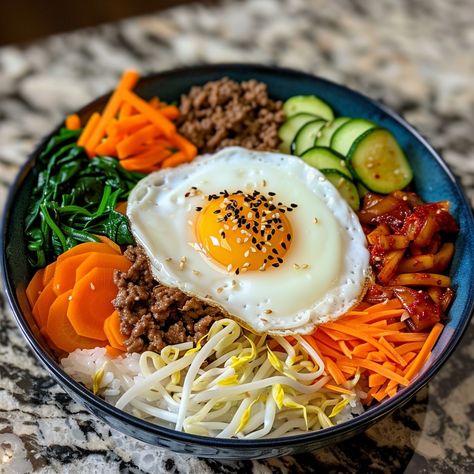 🥢 Dive into the flavors of Bibimbap! 🌶️ #KoreanCuisine #Bibimbap Bibimbap (Mixed Rice) Ingredients: Cooked rice (2 cups) Bean sprouts (1 cup, blanched) Carrot (1, julienned) Spinach (1 cup, blanched) Zucchini (1, julienned) Shiitake mushrooms (1 cup, sliced) Ground beef (1/2 cup, cooked) Kimchi (1/2 cup) Gochujang (2 tbsp) Sesame oil (1 tbsp) Sesame seeds (1 tbsp) Fried egg (1) Instructions: Arrange rice in a bowl. Place vegetables, beef, and kimchi on top. Add gochujang, sesame oil, and ... Kimchi And Rice, Bibimbap Bowl, Kimchi Rice, Bibimbap Recipe, Mixed Rice, Food Pic, Korean Rice, Instagram Recipes, Kimchi Fried Rice