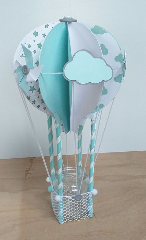 Pour une décoration de table sur le thème "montgolfière" pour un baptême, un anniversaire, une communion, un baby shower... ces montgolfières uniques et originales seront idéales pour décorer les tables principales, de buffet ou de cadeaux.avec son petit pot en verre, vous pourrez y glisser des friandises, des sucettes, des dragées.... une bougie à pile... articles fait-main, pièces uniques et personnalisables descriptif : réalisées principalement avec du papier couleur 135g/m2, et 98% d'objets Souvenirs Baby Shower Originales, Recuerdos Baby Shower Originales, Unique Table Decorations, Hot Air Balloon Craft, Recuerdos Primera Comunion Ideas, Clothes Decoration, Decoration Pieces, Table Clothes, Balloon Crafts