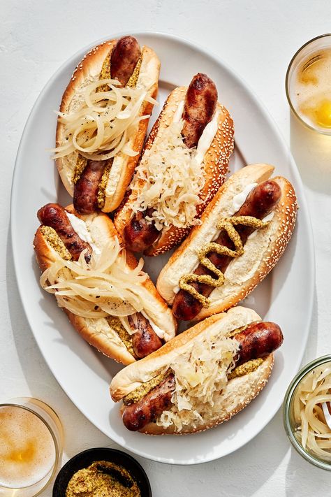 Simple, delicious brats take on subtle notes of beer and then are charred on the grill. Up your ballpark hotdog game for these homestyle beer brats. Beer Brats In The Oven, Bratwurst Hot Dog, Brats Recipes Grilling, Food For Bbq, Chicago Recipes, Beer Brats Recipe, Sandwich Photography, Gourmet Grill, Brats Recipes