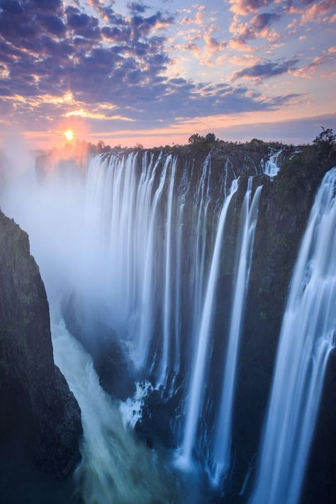 Experience the awe-inspiring Victoria Falls, one of the world's largest waterfalls, located in Zambia, Africa. A UNESCO World Heritage Site and a popular destination for adventure seekers and nature lovers. Zambia Aesthetic, Victoria Waterfalls, Victoria Falls Zambia, Nigeria Travel, Zambia Africa, Travel 2024, Rift Valley, Largest Waterfall, Africa Destinations