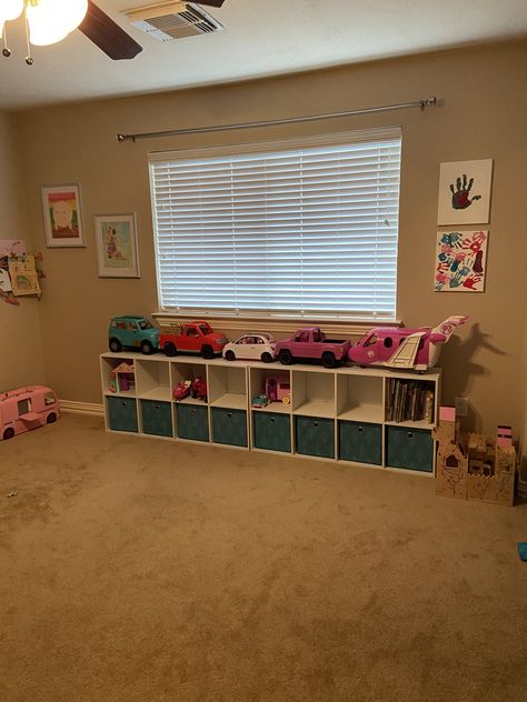 My girls have an insane amount of Barbie toys, vehicles and all the accessories. I’ve been searching for a way to store them neatly in there play room. So after hours of research I decided to use shelf units from Target. I have two side by side under the window ( pictured) and a taller one on the other side of the room. Book self/ toy storage. Done! Barbie Car Storage Ideas, Ways To Organize Barbie Stuff, Barbie Vehicle Storage Ideas, Barbie Organization Ideas, Barbie Storage, Barbie Organization, Organize Toys, Book Self, Shelf Units