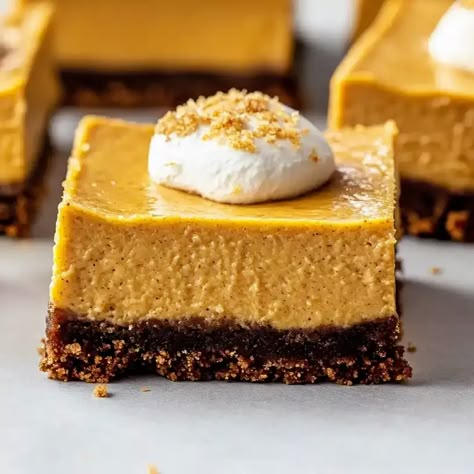 Discover the perfect fall dessert with our pumpkin cheesecake bars with gingersnap crust. Creamy pumpkin filling meets crunchy gingersnap crust Gingersnap Pumpkin Cheesecake, Pumpkin Ginger Snap Cheesecake, Pumpkin Cheesecake Gingersnap Crust, Ginger Snap Crust, Pumpkin Filling, Pumpkin Cheesecake Bars, Gingersnap Crust, Pumpkin Cheesecake Recipes, Mini Pumpkin Pies