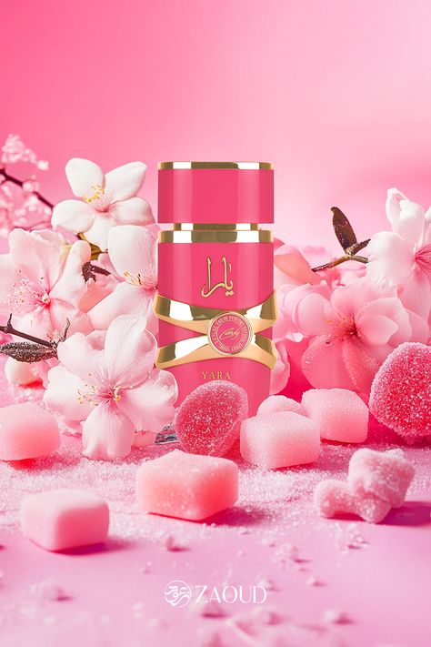 The image shows a pink-themed perfume bottle with the Arabic word "يَارَا" (Yara) on it in gold script. The bottle has a glossy finish and is accented with golden bands. The background is filled with delicate pink flowers and sugar-coated candies, creating a soft and sweet ambiance. The combination of the flowers and the candies emphasizes a feminine and floral scent, likely suggesting that the perfume has sweet and floral notes. Yara Candy Lattafa Perfume, Sweet Like Candy Perfume, Yara Perfume, Lattafa Yara, Perfume Sweet, Cruise Ship Pictures, Candy Perfume, Ship Pictures, Barbie Bridal