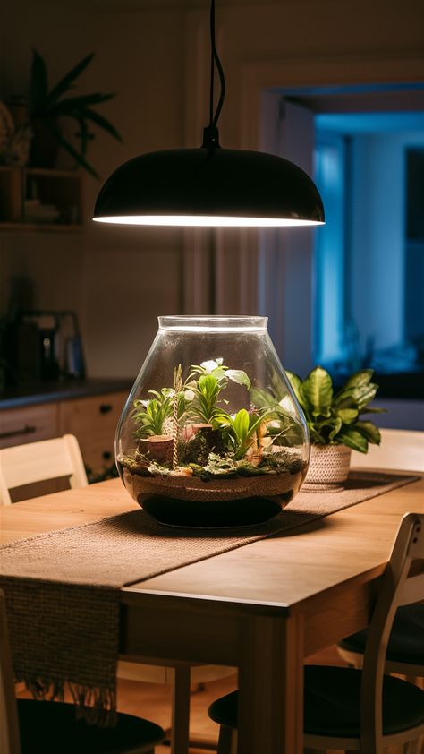 Transform your dining area into a welcoming haven with a beautiful terrarium as the centerpiece on a solid wood NORDEN table. Paired with stylish INGOLF chairs and a chic SOMMAR 2023 table runner, this setup is perfect for enhancing meal times. Add personality with a decorative FEJKA artificial plant and enjoy the warm ambiance created by a HEKTAR pendant lamp overhead. Ready to elevate your dining space? Discover more ideas and tips for creating a convivial atmosphere! #HomeDecor #DiningInspiration #TerrariumLove #IKEAStyle #InteriorDesign #CozyDining #TableStyling Hektar Pendant, Norden Table, Terrarium Centerpiece, Beautiful Terrariums, Dining Inspiration, Meal Times, Add Personality, Dining Space, Dining Experience