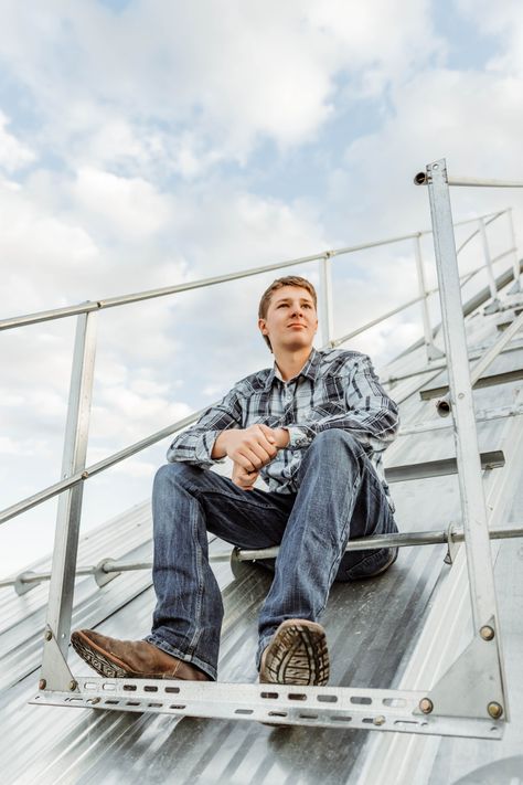 Boy sits on corn bin for senior photos Grain Bin Senior Pictures, Senior Pictures With Tractors, Senior Farm Pictures Boys, Tractor Senior Pictures, Barn Senior Pictures, Farm Senior Pictures, Senior Pictures Boy Poses, Guy Poses, Senior Photos Boys