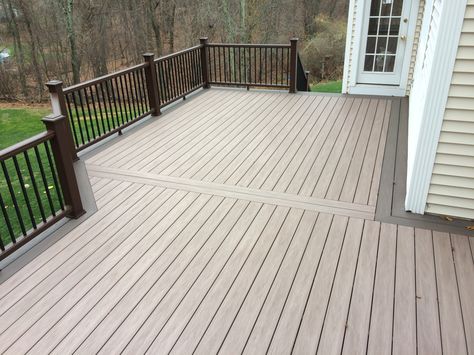 Beautiful Wolf decking boards in Weathered Ipe were used for the main decking, double feature strip & stair treads. Black Walnut was incorporated into the design via a double mitered picture frame border, stair risers & fascia throughout. Trex Transcends composite railings with black square aluminum balusters & island caps complete this gorgeous deck. This family will enjoy an incredible outdoor living space! Timbertech Deck Ideas, Wolf Decking, Picture Frame Border, Deck Cost, Second Story Deck, Aluminum Balusters, Decking Boards, Beautiful Wolf, Deck Pictures