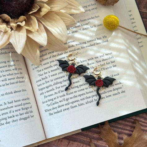 These dragon earrings are still a favorite 😍 #dragonearrings #fourthwinginspired #cuteearrings #handmadejewelry #handmadeearrings #whimsicalart #artistsoninstagram #artist #clayearrings #clayearringsofinstagram #clayjewelry #cuteaccessories #trendyearrings #bookish #bookishearrings #bookworm #readersofinstagram #smallbusiness Bookish Earrings, Cloud Design, Dragon Earrings, Polymer Earrings, Clouds Design, Trendy Earrings, Clay Ideas, Diy Clay, Whimsical Art