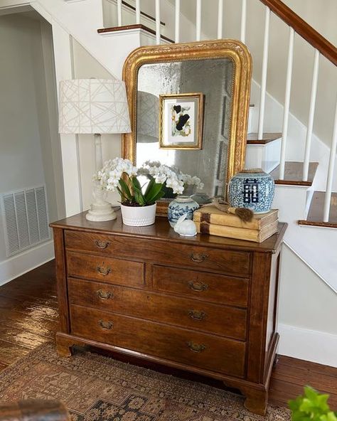 Joan on Instagram: "The spring entry chest! Antique English chest of drawers topped with an antique Louis Phillippe mirror, a vintage alabaster lamp with a fun geometric (tone on tone shade), circa 17th c. Vellum covered books, antique Chinese double happiness and Canton- blue and white ginger jars, an antique Chinese horn-handled natural bristles brush, and a white planter filled with real white orchids (sans hair clips😉) ,and a white porcelain rabbit that was in my Easter basket when I was a Entry Chest Of Drawers, Chest Of Drawers Entryway, Ginger Jar Decor Ideas, Painting On The Mirror, Condo Entryway, 1930s Furniture, Blue And White Ginger Jars, Books Antique, Drawer Decor