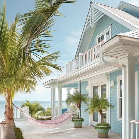 Coastal paradise home with pastel blue facade and hammock on beachfront - ideal for relaxation by the sea White Beach House Exterior, Big Beach House, Blue Facade, White Beach House, Beach Hammock, Beach House Exterior, Dream Beach Houses, Ocean Sounds, Beach House Interior