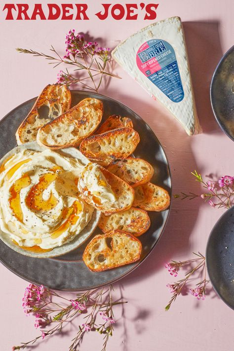 Trader Joe's Double Cream Brie; shown as recipe for Whipped Double Cream Brie; topped with Spicy Honey Sauce and cracked pepper grinds; on black plate with toasted crostini Whipped Brie, Fancy Grilled Cheese, Toasted Crostini, Joe Recipe, Trader Joes Recipes, Double Cream, Honey Sauce, Spicy Honey, Cracked Pepper