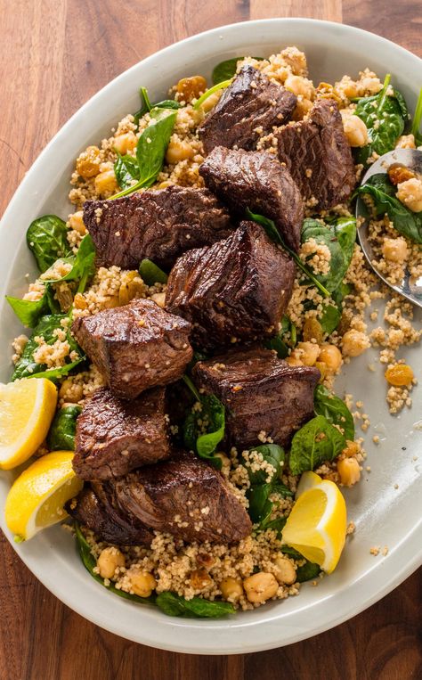 Moroccan Steak Tips and Couscous: Our Moroccan Steak Tips and Couscous recipe is the perfect weeknight one-pan meal that is anything but boring. Warm spices like cinnamon and cumin liven up quick-cooking sirloin while chickpeas, couscous, and spinach complete the meal. Moroccan Beef, Steak Tips, Dish Ideas, Couscous Recipes, America's Test Kitchen Recipes, Kitchen Recipe, America's Test Kitchen, Moroccan Food, Fool Proof Recipes