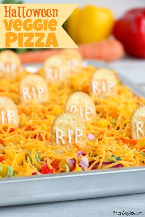 Halloween Veggie Pizza - A spooky themed graveyard pizza featuring a flavorful ranch cream cheese covered crust, topped with colorful veggies and "tombstone" crackers.