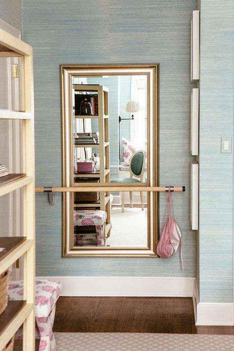 A silver leaf beveled mirror hung from a pale blue grasscloth wallpapered wall is fitted behind a ballet barre in an elegantly designed girl's bedroom. Grasscloth Wallpaper Bedroom, Ballet Bedroom, Dance Bedroom, Ballet Room, Home Dance Studio, Ballet Bar, Bedroom Closet Doors, Shared Girls Bedroom, Dance Rooms