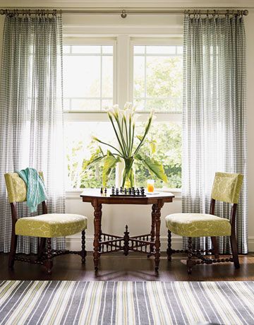 The room's generous windows streaming with sunlight make an irresistible spot to put a game table for playing chess or doing jigsaw puzzles on a lazy afternoon. Chairs from Edward Ferrell are upholstered in Bergamo's Castor. Linen sheers filter light and add a more lush, private feeling at night.   - HouseBeautiful.com Striped Rugs, Small Seating Area, Trendy Living Rooms, Game Table, Family Room Design, Style At Home, Formal Living Rooms, Furniture Arrangement, Front Room