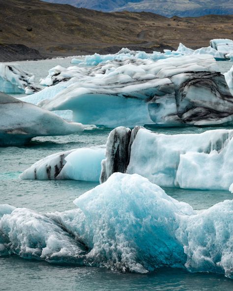 The icebergs at Jökulsárlón are a breathtaking display of nature's artistry, with vibrant shades of blue, white, and even black. Each iceberg is uniquely shaped and colored, reflecting the light in a mesmerizing dance as they drift across the glacial lagoon. 📍 Jökulsárlón, Glacier Lagoon, Iceland #iceland #hiddeniceland #guidetoiceland #lostiniceland #wheniniceland #inspiredbyiceland #visiticeland #jokulsarlon #WanderlustEurope #adventurerig #travelinspiration #instaadventure Lagoon Iceland, Visit Iceland, Travel Photographer, Iceland, Shades Of Blue, Belgium, Travel Inspiration, Blue White, Photo And Video