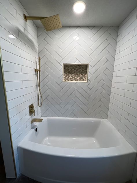 My dad is a tileman and installed this beautiful white subway tile with mosaic in the niche. I love all the gold accents and the herringbone design! Cant wait to decorate this bathroom! White Subway Tile Herringbone Bathroom, Subway Tile Herringbone Bathroom, White Subway Tile Herringbone Backsplash, Herringbone Backsplash Bathroom, Subway Tile Bathtub, White Herringbone Tile Bathroom, Bathroom Tile Herringbone, White Subway Tile Herringbone, Bathroom Remake