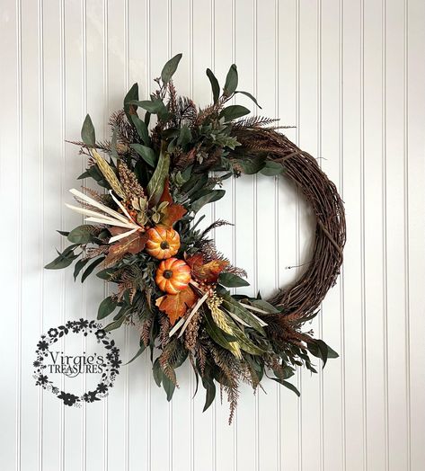 MADE TO ORDER.  This lush and beautiful wreath will make a great statement on your door! Made with quality eucalyptus leaves, Rucus leaves, pumpkin picks & spiked ferns give the wreath a classic and timeless style.  Made on an 18 inch grapevine wreath. Measures 20-24 inches in diameter.  Makes a special gift! All sales are final. No refunds or cancellations. Be sure to visit www.facebook.com/virgiestreasures and like page to see updates on new merchandise! Fall Silk Arrangements Floral Design, Fall Magnolia Wreath, Vintage Fall Wreath, Trending Wreaths, Fall Swags For Front Door, Fall Wreath Ideas Diy, Grapevine Wreath Christmas, Diy Fall Wreaths, Unique Fall Wreath