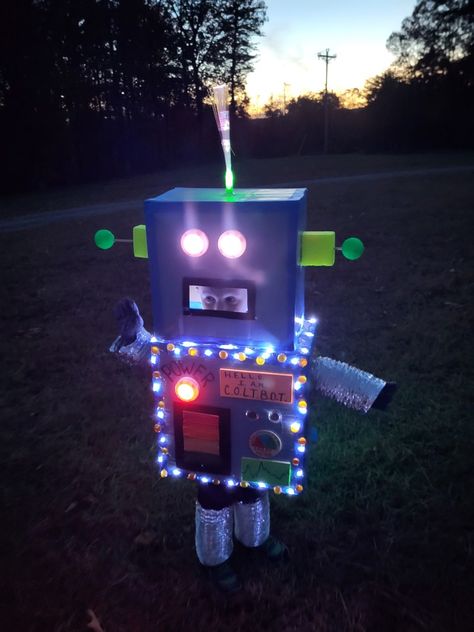 Use of cardboard boxes, battery operated lights, spray paint, hot glue, painter's tape and other craft supplies Halloween Robot Costume, Wild Robot Costume, Robot Costume Toddler, Diy Robot Costume Toddler, Robot Costume, Futuristic Robot Costume, Adult Robot Costume, Easy Robot Costume, Toddler Robot Costume