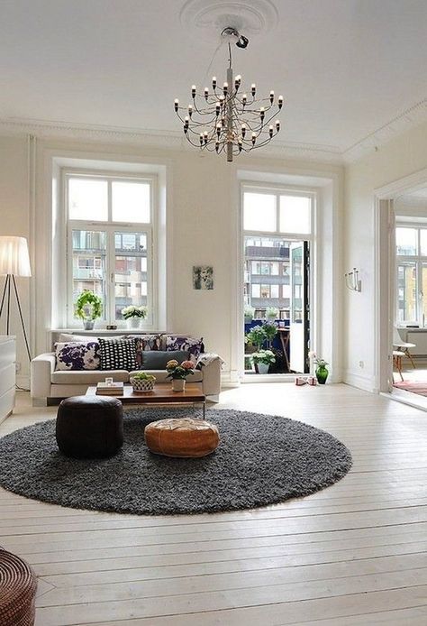 Although rectangular shaped rugs are the go-to shape when rug shopping, choosing a round rug could be the better choice for your room. Read on for tips! Scandinavian Apartment, Design Apartment, White Floors, Design Del Prodotto, Room Interior Design, Round Rug, A Living Room, Apartment Design, Home Fashion