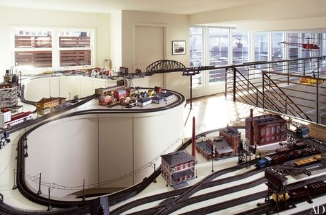 The mezzanine of this Tribeca penthouse is devoted to the husband and son’s model trains, which circle the living room using a cantilevered track on the catwalk railing. “The industrial element of the train collection inspired the mood of the interiors from the very beginning,” remarks designer Stephen Sills, who collaborated with designer James Huniford and architect Robert Kahn to transform this New York apartment. Mezzanine Design Ideas, Mezzanine Design, Tribeca Penthouse, Tommy Bahama Living Room, Floor Bedroom Ideas, Country French Living Room, Concrete Interior Design, Set Room, Mezzanine Floor