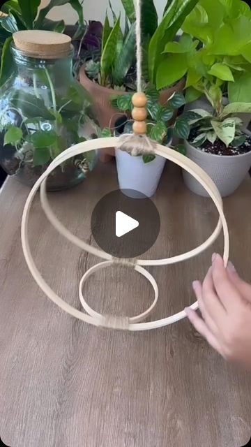 Thousands of Tips on Instagram: "Eeasy DIY hanging planter!  Just grab three wooden hoops – two large and one slightly smaller. Use small one for the base, and connect the larger hoops on either side of the small one, meeting at the top like a charming arch.  For a clean finish, hide the plastic lockers connection wrapping some natural sisal cord around the lockers. Don’t forget to leave a long strand of cord for hanging!  Voila! Your unique triple-hoop planter is ready to cradle your favorite light-weight vase, adding a touch of vertical greenery to any room. So grab your hoops, get creative, and let your plants hang out in style! #DIYPlanterProject #TripleHoopVibes #HangingPlantGoals #ThriftyHomeDecor #PlantParentHacks #UpcycledHoops #BohoPlantLife #MacrameMagic #SisalCordLove #VerticalG Diy Hanging Planter, Planter Project, Plant Goals, Macrame Hanging Planter, Eco Friendly Decor, Deck Decorating Ideas On A Budget, Natural Sisal, Macrame Hanging, Wooden Hoop