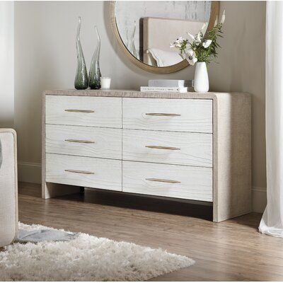 Svelte and sophisticated in a serene two-tone finish combining a palette of white, cream, and taupe, the dresser with six self-closing drawers is a stylish statement piece brimming with storage. The top drawers have a removable gray felt liner, the right top drawer has a removable gray felt jewelry tray, and the bottom drawers are cedar-lined. The outside of the case is in pebble beach, a lacquered burlap finish, and the drawer fronts are in a soft white finish in cast resin accented by champagn Two Tone Dresser, Grey Dresser, Six Drawer Dresser, 7 Drawer Dresser, 9 Drawer Dresser, Neutral Bedroom, Felt Jewelry, Double Dresser, 6 Drawer Dresser