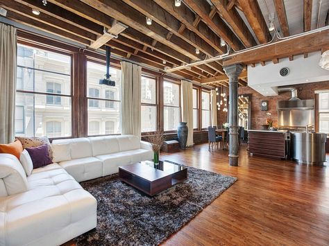 Plush couch in white adds a touch of contemporary class to the room Cozy New York City Loft Enthralls With An Eclectic Interior Wrapped In B... New Yorker Loft, Open Plan Apartment, Nyc Loft, Exposed Ceilings, Minimalistic Interior, House Plan With Loft, Soho Loft, New York Loft, Loft Stil