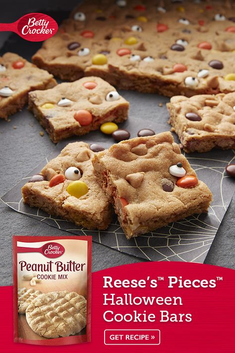 Celebrate halloween with these REESE'S PIECES™ Halloween Cookie Bars that boast Betty Crocker™ peanut butter cookie mix, REESE'S PIECES™ Peanut Butter Chips and candies. Your little ghosts and goblins will gobble up this easy dessert and have fun baking them! It's the perfect bar for your Halloween party! Halloween Cookie Bars, Betty Crocker Peanut Butter Cookies, Reese's Cookies, Reeses Cookies, Peanut Butter Cookie Bars, Ghosts And Goblins, Reese's Pieces, Candy Eyeballs, Easy Peanut Butter Cookies