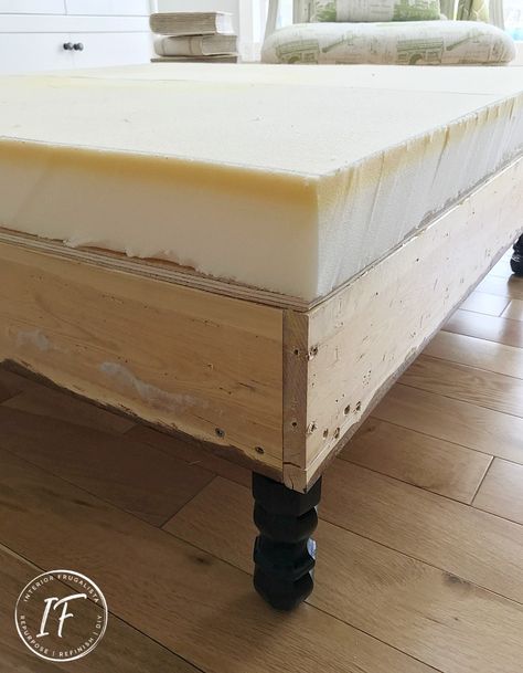 How to build a large square upholstered ottoman with dark walnut decorative trim that can be made with or without power tools. A budget-friendly DIY furniture idea by Interior Frugalista Diy Ottoman Coffee Table, Upholstered Ottoman Coffee Table, Square Ottoman Coffee Table, Diy Footstool, Diy Storage Ottoman, Large Square Ottoman, Diy Furniture Upholstery, Upholstered Coffee Tables, Diy Stool