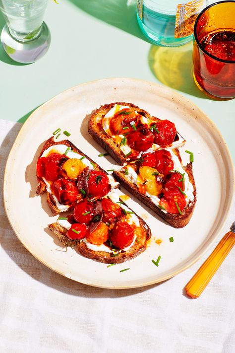 Cherry tomatoes in the summer have a magical pull. They are sweet, juicy flavor bombs that don't need a lot of work to stand out in a recipe. Simply blistering them in a pan with a little garlic and salt makes them jammy in no time. In just a few minutes they’re ready to be slathered over tangy yogurt or labneh, topped with fresh chives and oily anchovies for a punch of umami. Big toasts make great dinner, and we know it. Cherry Tomato Toast, Tomato Toast Recipe, Italian Picnic, Blistered Cherry Tomatoes, Tomato Toast, Veggie Mains, Vegetarian Mains, Summer Sides, Magazine Recipes