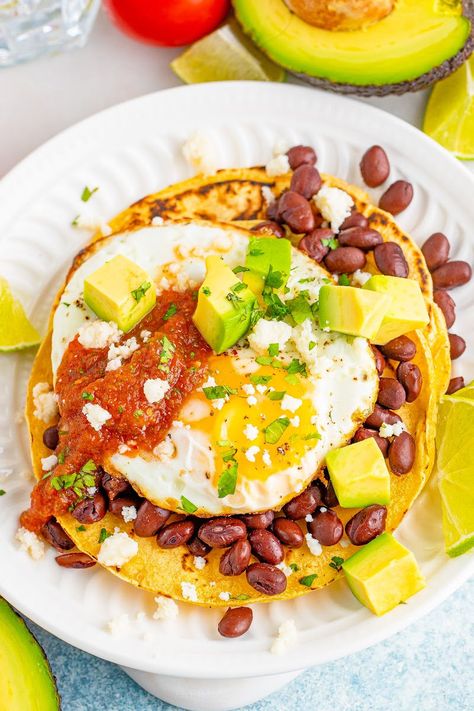 Huevos Rancheros is a deliciously easy Mexican breakfast made with eggs, tortillas, and beans that will keep you fueled all morning long! #BreadBoozeBacon #huevosrancheros #eggs #tortilla #beans #refriedbeans #blackbeans #quesofresco #salsa #breakfast #brunch #mexicanfood #texmex #cincodemayo Tortilla Egg Breakfast, Eggs And Tortillas, Easy Mexican Breakfast, Salsa Breakfast, Beans And Eggs, Huevos Rancheros Recipe, Bread Booze Bacon, Restaurant Style Salsa, Mexican Breakfast