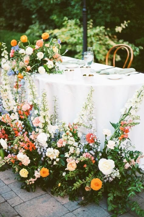 Natural Whimsical Decor, Rounded Arch Wedding, Spring Wedding Trends 2023, Colorful Wedding Florals Summer, Bright Sweetheart Table, Summer Garden Wedding Florals, Summer Wedding Sweetheart Table, Spring Dusty Blue Wedding, Marigold Flower Centerpiece