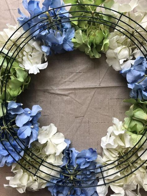 I love hydrangea blooms! They look gorgeous in a vase and make the most beautiful wreaths. In fact, this is the easiest wreath I have ever made. If you need a beautiful decoration for your home, let me show you how to make a Spring wreath using hydrangea blooms!For more DIY Home Decor ideas from An Organized Season, click HERE!The original wreath Originally, I made the hydrangea wreath for my front door in Kentucky. When I removed the wreath to pack it, I had a big surprise! A bir… Wreaths With Hydrangeas, Hydrangea Wreaths For Front Door, Artificial Hydrangea Wreath, Blue Hydrangea Wreath Front Doors, Hydrangea Hoop Wreath, Hydrangea Grapevine Wreath, Hydrangea Wreath Diy, Hydrangea Door Wreath, White Hydrangea Wreath