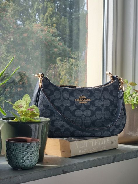 Coach Teri Shoulder Bag in Signature Denim Blue with gold hardware, A Little Life by Hanya Yanagihara, plants Coach Purses Blue, Coach Denim Shoulder Bag, Coach Blue Shoulder Bag, Coach Blue Bag, Blue Coach Shoulder Bag, Denim Coach Bag, Coach Denim Bag, Blue Coach Bag, Coach Teri Shoulder Bag