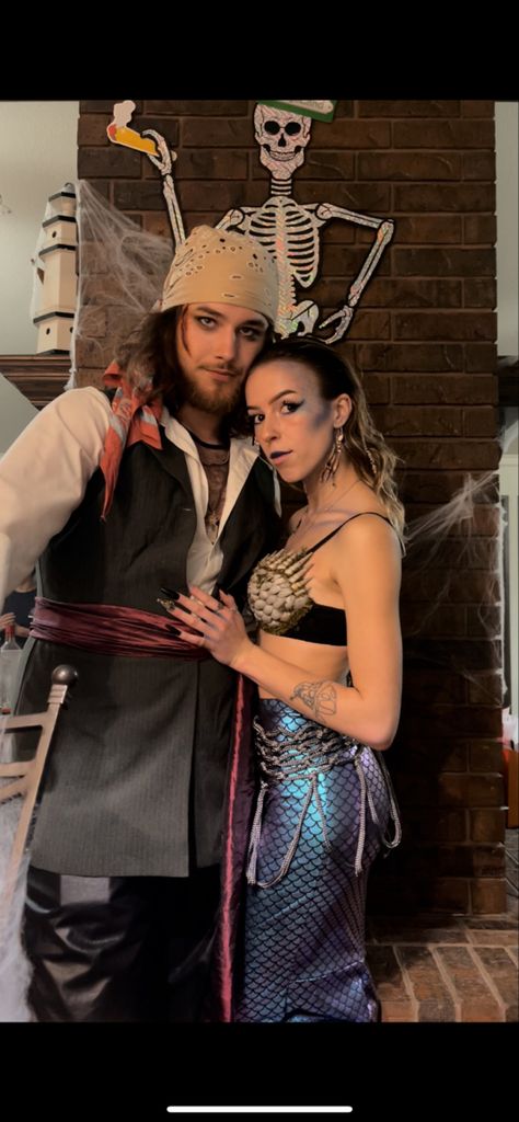 Couple Halloween Costumes Mermaid, Siren Couples Costume, Merman Halloween Costumes, Siren And Sailor Costume Couples, Sea Captain And Siren Costume, Mermaid And Pirate Halloween Costumes, Siren Sailor Costume, Pirate And Mermaid Costume Couple, Siren And Sailor Halloween Costume