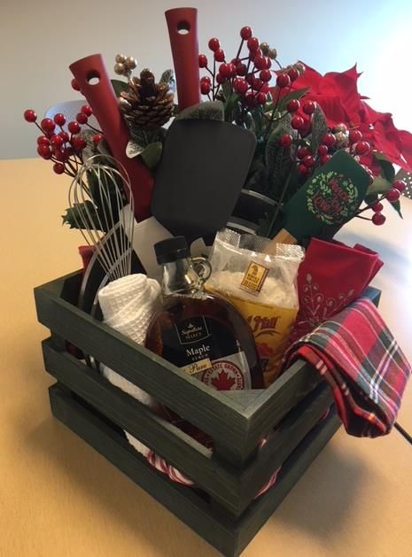 Staff Holiday Basket for the raffle....so cute.  Items purchased at Walmart, Safeway, and Burlington.  Created for just under $100.00.  the picture doesn't show the pans very well but there are 2 nice pans in the basket, pancake mix, maple syrup, about 6 christmas dishtowels, a spatula and a whisk. Could be made less expensive with only 1 pan and less towels and tools. Christmas Raffle Basket Ideas Fundraising, Winter Raffle Basket Ideas, Bushel Basket Christmas Ideas, Maple Syrup Gift Basket Ideas, Silent Auction Gift Basket Ideas Christmas, Christmas Raffle Basket Ideas, Jingle Baskets, Baking Basket Ideas Silent Auction, Buffalo Plaid Gift Basket