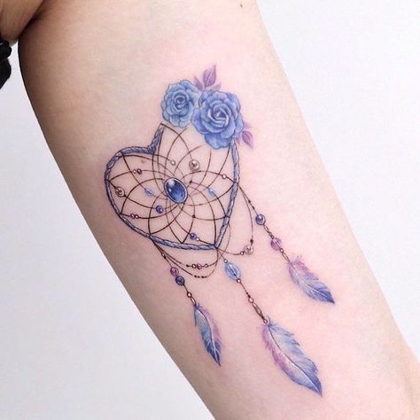 heart-shaped-dream-catcher-tattoo-on-back-watercolor-pink-blue-roses-on-the-side Heart Dreamcatcher Tattoo, Dreamcatcher Tattoo Thigh, Dreamcatcher Tattoo Meaning, Atrapasueños Tattoo, Sunflower Tattoo Simple, Inside Of Arm Tattoo, Mandela Tattoo, Mini Tats, Dream Catcher Tattoo Design