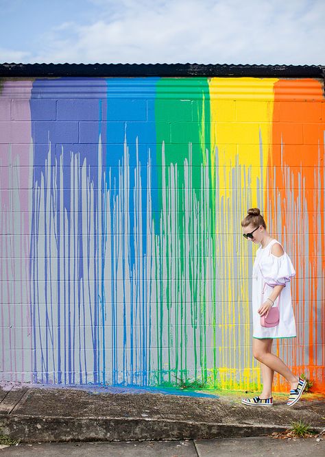 Blogger Bella Bucchiotti of xoxoBella is wearing a Chicwish cold shoulder dress that is white with colorful trim and Keds at a rainbow mural in Houston. Paint Drip Wall, Sunday School Themes, Drip Wall, Rainbow Wall Mural, Rainbow Mural, Colorful Trim, Circle House, Interior Murals, Facade Architecture Design