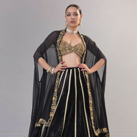 The classic black silk velvet lehenga features a light golden border and a heavy metallic sequins zardozi border. Paired with a full zardozi embroidery sweetheart neck blouse, the set exudes elegance. Completing the ensemble is a black silk Georgette dupatta cum cape, featuring metal sequins and a dabka zardozi border. #BlackVelvetLehenga #ZardoziEmbroidery #SilkGeorgetteDupatta #BridalElegance #RichaAhluwalia #festivewear #bridalcouture #handcraftedclothing #indianwedding #bridesofinstagram ... Zardozi Border, Sweetheart Neck Blouse, Golden Lehenga, Golden Blouse, Velvet Lehenga, Black Lehenga, Zardozi Embroidery, Golden Border, Georgette Dupatta