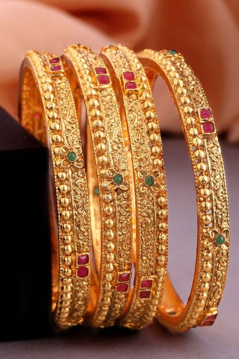 Set of four 24K gold-plated red and green stone-studded handcrafted bangles, has filgree design detailing. . . bangles #bangleslove #handcraftedbangles #goldlove Nose Accessories, Antique Necklace Gold, Plain Gold Bangles, Filigree Bangle, Gold Earrings For Kids, Gold Bangles Indian, Gold Bangles For Women, New Gold Jewellery Designs, Antique Gold Jewelry Indian