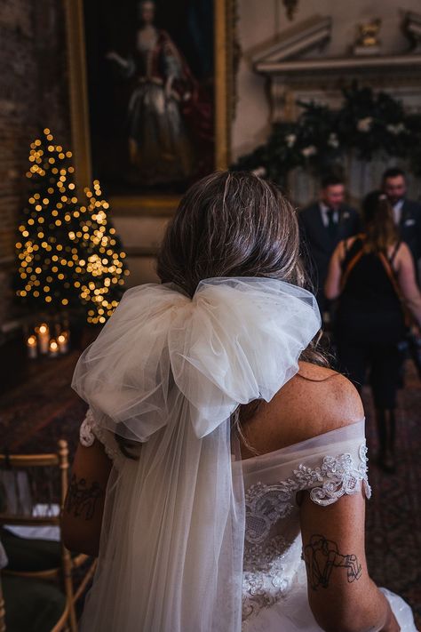 Bride in off the shoulder princess wedding dress wearing oversized bow wedding veil Winter Wedding Veil, House With Library, Bow Wedding Veil, Cosy Library, Retro Wedding Cakes, Secret Basement, Bridal Bow, Christmas Wedding Decorations, Country House Wedding Venues