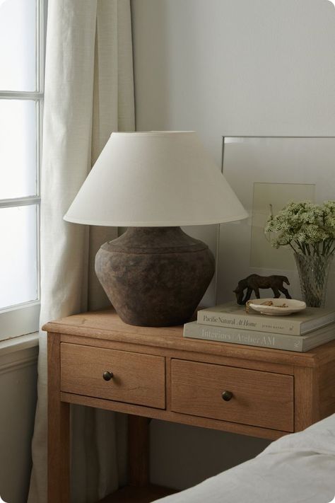 - Step 1: Choose a stylish, high-quality piece made to last that matches your space and provides plenty of storage options. - Step 2: Add a statement-making lamp for that relaxing evening glow. - Step 3: Finish with your favorite books and botanicals for a fresh, casual appeal. #MyPotteryBarn  📸: Tessa Neustadt Style A Nightstand, How To Style A Nightstand, Bedroom Ideas Furniture, Warm And Cozy Bedroom, Pottery Barn Bedrooms, Nightstand Styling, Bedroom Oasis, Sanctuary Bedroom, Serene Bedroom