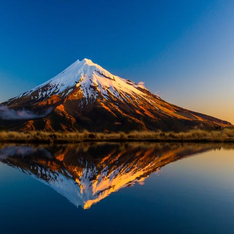 🏞️ Known as New Zealand's "most climbed mountain", Mt Taranaki is a dormant stratovolcano located on the west coast of the North Island, and is the Island's second highest mountain, after Mount Ruapehu. This almost symmetrical mountain is surrounded by lush forests, picturesque hiking trails, and beautiful waterfalls that are sure to please avid hikers and nature enthusiasts alike. 💚 Mount Ruapehu New Zealand, Mt Kosciuszko Australia, Mt Taranaki, Mount Taranaki, Mount Maunganui, Photoshop Painting, Mountain Climbing, Beautiful Waterfalls, Butterfly Wallpaper