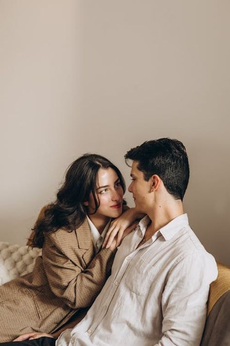 Couple Sitting Together · Free Stock Photo Couple Taking Photo Together, Close Couple Poses, Couple Poses On Couch, Couple Pose Sitting, Couples Sitting Poses, Couple Poses Sitting, Couple Sitting Together, Couple Embracing, Engagement Session Posing