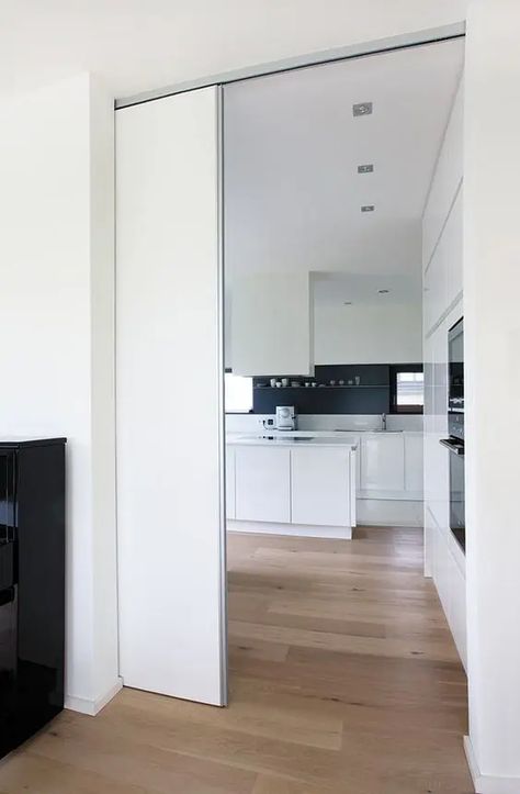 a sleek white pocket door is a cool and minimalist way to separate the spaces without spoiling any interior and look French Pocket Doors, Interior Pocket Doors, Cavity Sliding Doors, Glass Pocket Doors, Internal Sliding Doors, Barn Style Sliding Doors, Sliding Wall, Sliding Pocket Doors, Sliding Door Design