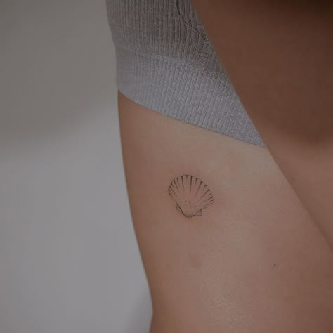 The Best Tattoos, Delicate Shell Tattoo, Shell Tattoo Placement, Seashell Rib Tattoo, Minimal Shell Tattoo, Dainty Shell Tattoo, Shell With Pearl Tattoo, Dainty Rib Tattoos, Shell Tattoo Design