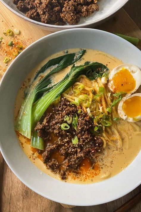 A serving of tantanmen ramen in a white bowl with ramen noodles topped with spicy minced meat, baby bok choy, one jammy ramen egg sliced in half, and garnished with green onions, sesame seeds and shichimi togarashi. On the side is another white bowl with more spicy minced meat. Simple Ramen Recipes, Home Made Ramen Noodles, Creamy Ramen Recipe, Tantanmen Ramen Recipe, Tantan Ramen, Healthy Ramen Recipes, Tantanmen Ramen, Creamy Ramen, Tan Tan Ramen