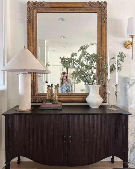 Sideboard styling — mirror is vintage but linked similar! lamp, vase, greenery stems, candleholder Glass Sideboard Styling, Moody Modern Vintage, Vase Greenery, Styling Mirror, Parisian Dining Room, Sideboard Styling, Sideboard With Mirror, Lamp Vase, Sideboard Mirror