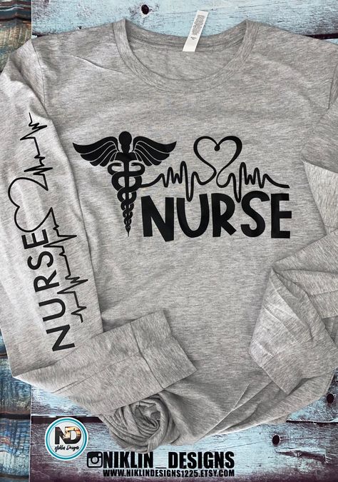 How perfect is this long sleeve lightweight T-shirt that is also soft feel, a great addition to anyone's closet for the Hard working nurse. Great for the in between weather is this shirt. It features the word Nurse on the front in silk screen with the heart and heartbeat and down the sleeve the word nurse with the heart and heartbeat in black vinyl . No way can anyone go wrong with this top.  This is a light heathered grey top pictured. Tear-away label Ribbed cuffs Sideseamed Retail fit Triblends - 3.8 oz., 50% poly, 25% combed ringspun cotton, 25% rayon, 40 singles All other Heather colors are 52% combed and ringspun cotton, 48% polyester Athletic Heather is 90/10 combed ringspun cotton/poly Ash is 99/1 combed ringspun cotton/poly 30 singles 4.2 oz., 100% combed and ringspun cotton All or Nursing T Shirt Ideas, Nurse Shirts Ideas Design, Nurse Shirts Vinyl, Nurse T Shirts Ideas, Nurse Shirts Ideas, Nursing T Shirts, Nurse T Shirts, Nurse Clothing, Shirt Slogans