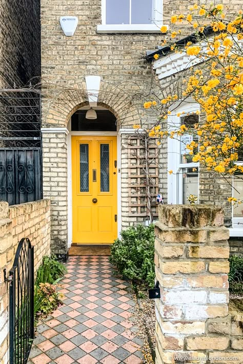 This yellow door and yellow flowering tree in London are great front garden ideas. This brick house exterior in Peckham, London has a great yellow front door and matching yellow flowers. It’s a great yellow door house. #yellowdoor #doors #door #frontdoor #frontdoorideas #house #housedesign #brickarchitecture #frontgarden #frontgardendesignideas #frontyard Yellow Brick Houses, Yellow Front Door, Brick House Exterior, Front Garden Ideas, Peckham London, Front Door Inspiration, Yellow Front Doors, Door House, Yellow Door